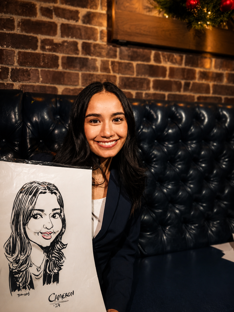 Young woman holding her black-and-white caricature at a cozy holiday community social