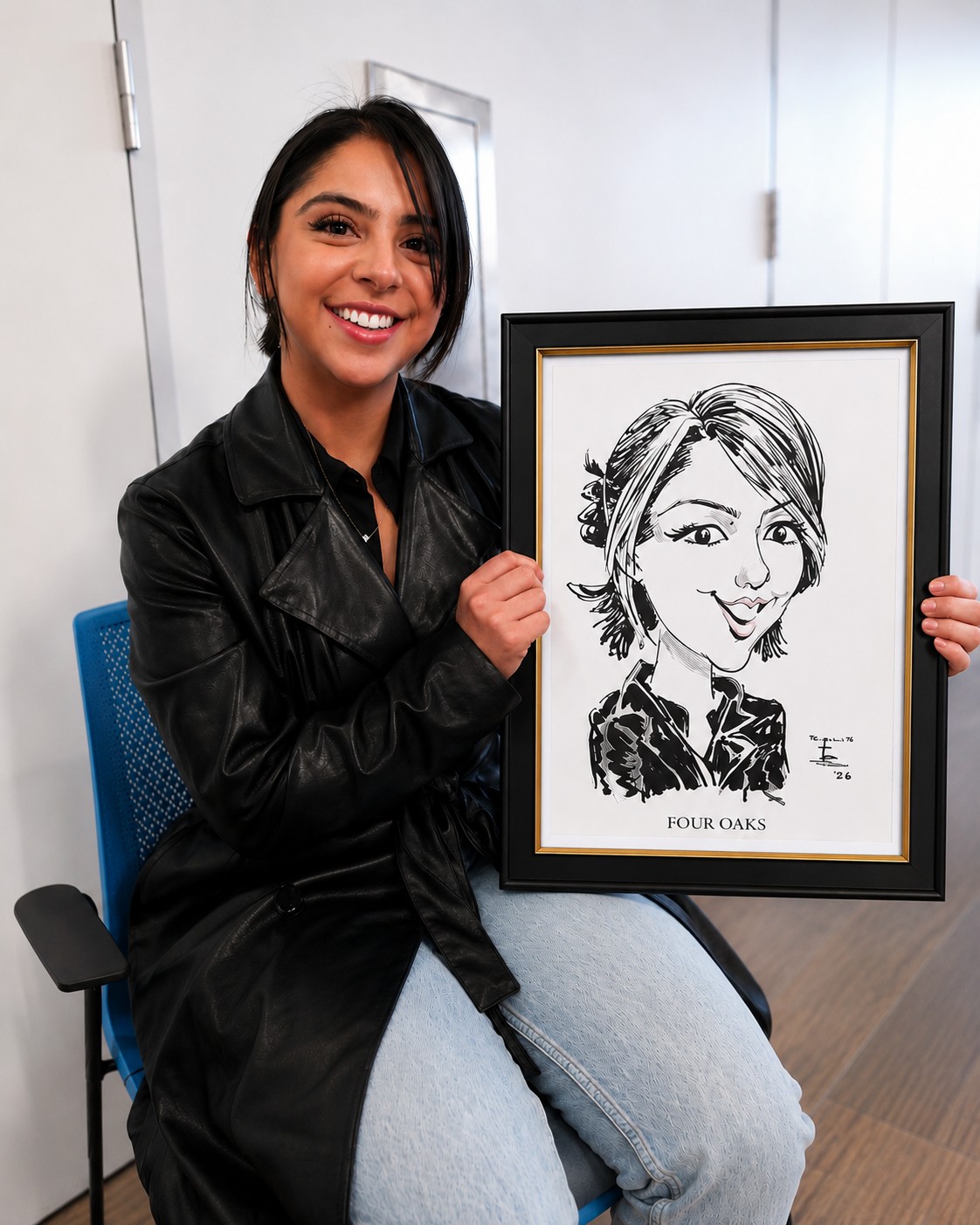 Happy client holding her framed caricature keepsake