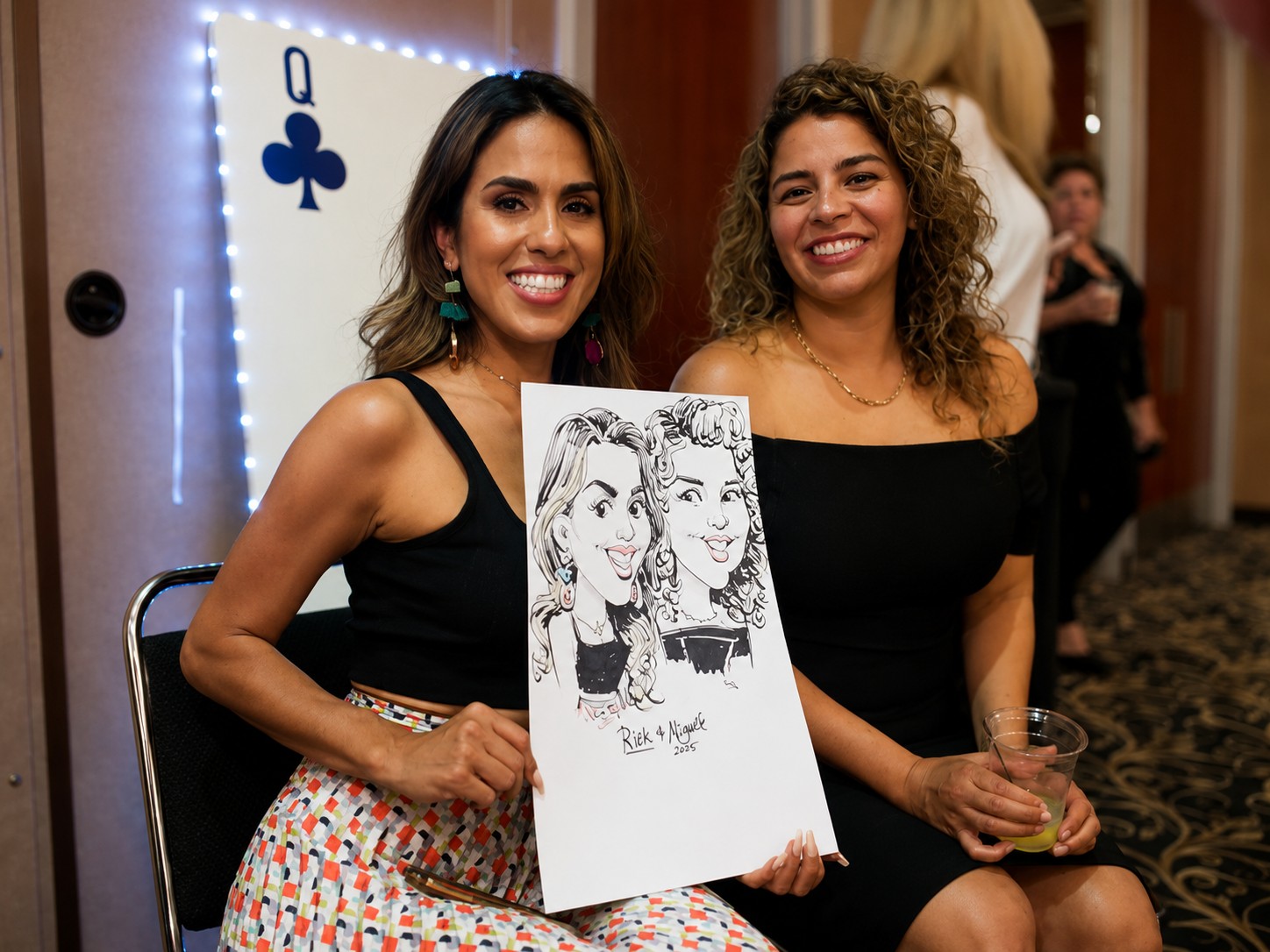 Two women holding a duo caricature at a corporate casino night event