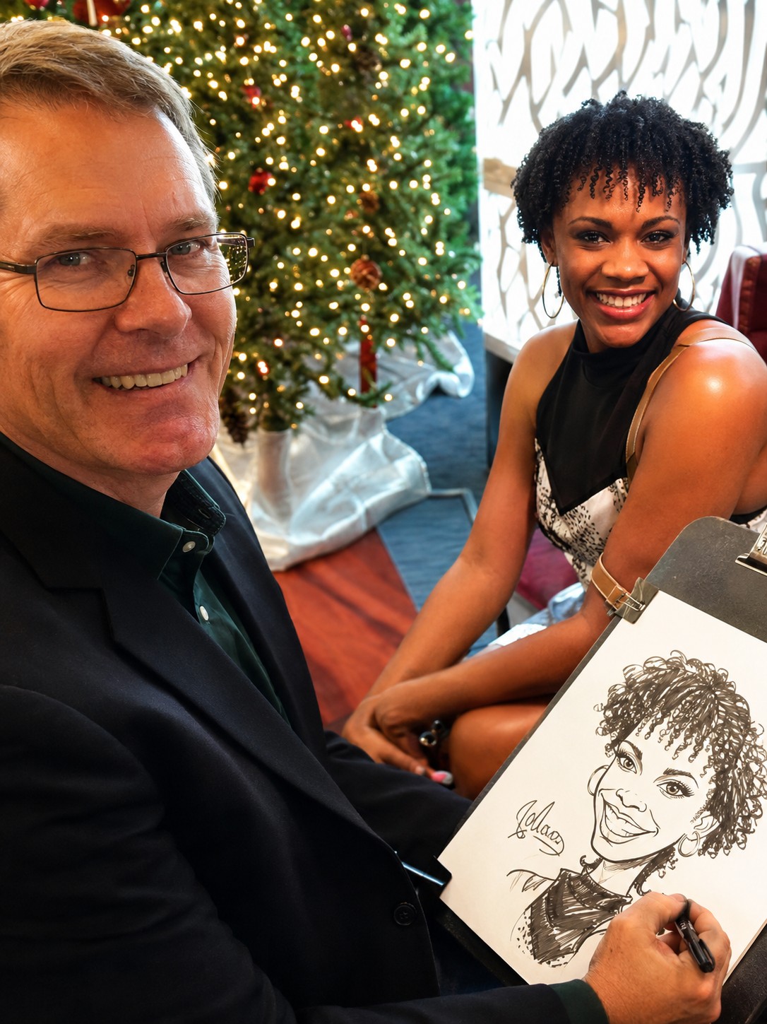 Jody drawing a caricature for a woman at a holiday event with a Christmas tree