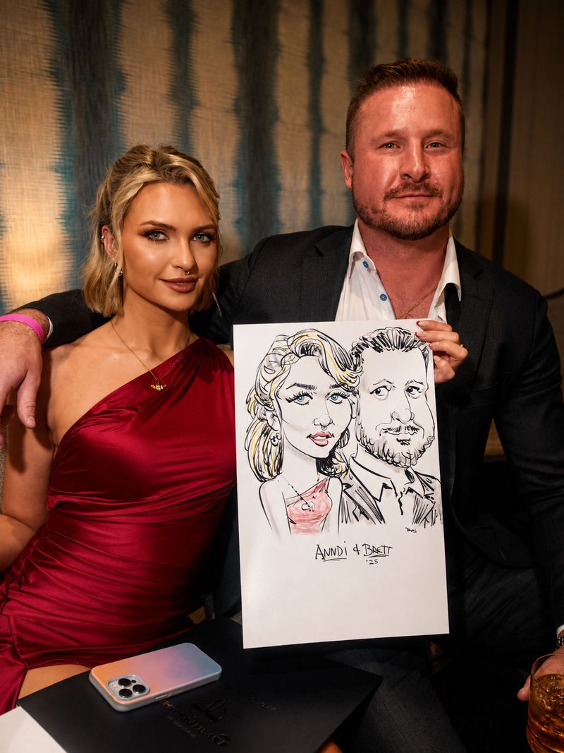 Couple in formal attire holding a color caricature at a company holiday party